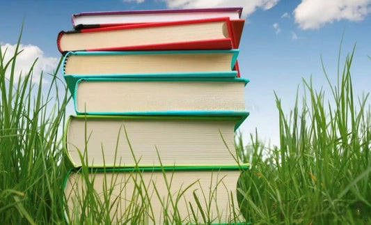 Stack of paperback books representing self-publishing book printing costs