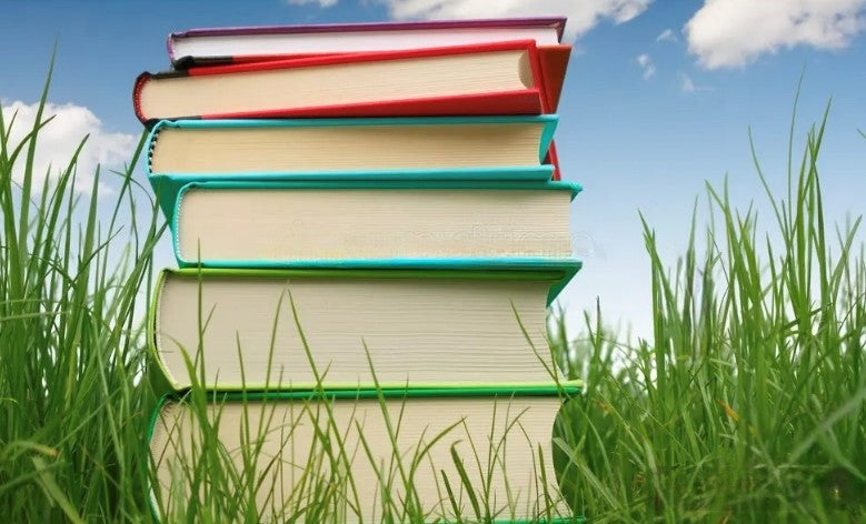 Stack of paperback books representing self-publishing book printing costs